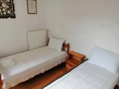 two beds sitting next to each other in a room at Villa Stefania - with Sea View Terrace in Drapaniás