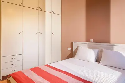 a bedroom with a bed with white cabinets at Filio House in Stalos