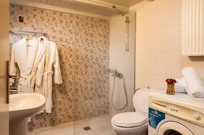 a bathroom with a toilet and a sink and a shower at Filio House in Stalos