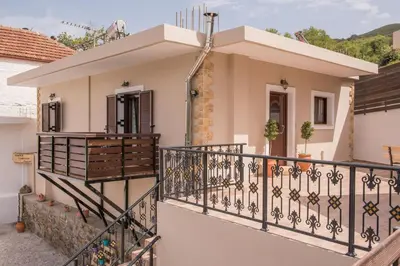 a house with a balcony with a fence at Marika Traditional Home in Élos