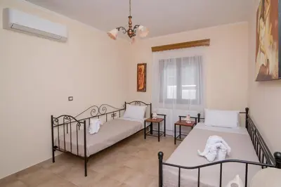 a bedroom with two beds and a window at Marika Traditional Home in Élos