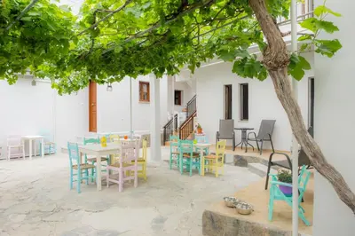 a patio with colorful chairs and tables in a building at Stellar Apartments I in Plataniás