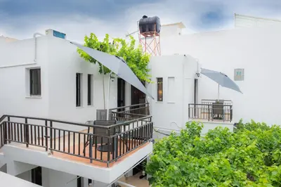 a balcony view of a white building with plants at Stellar Apartments I in Plataniás
