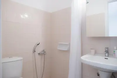 a bathroom with a shower and a toilet and a sink at Stellar Apartments I in Plataniás