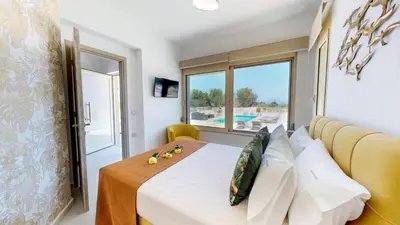 a bedroom with a bed and a window at Liberty & Freedom Luxury Villa-heated pool in Plataniás