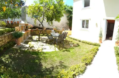 a garden with a table and chairs in a yard at Cactus in Nopíyia