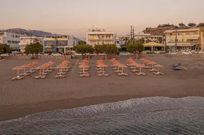 a group of chairs and umbrellas on a beach at Pal Beach in Palaiochóra