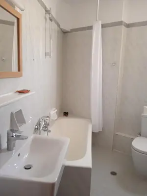 a bathroom with a sink and a tub and a toilet at Pal Beach in Palaiochóra