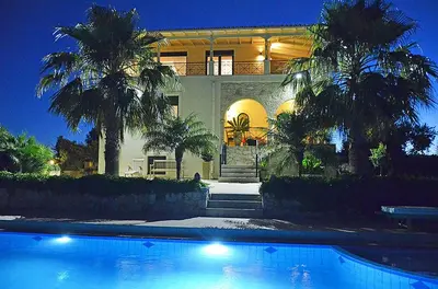 a large house with a swimming pool in front of it at Villa Europa - Western Crete - Chania in Darmarochori