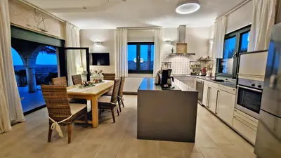 a kitchen with a table and chairs in a room at Villa Europa - Western Crete - Chania in Darmarochori