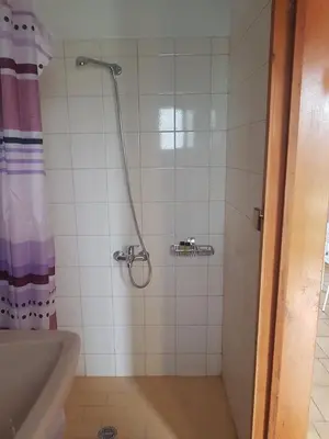 a bathroom with a shower with a shower curtain at Piccolo Paradiso Apartments in Kato Daratso