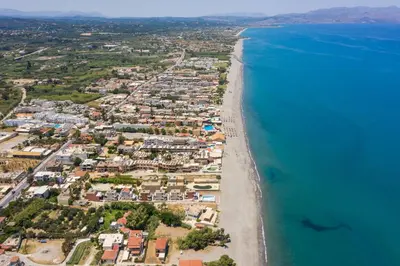 an aerial view of a beach and the ocean at Cretan Blu Platanias in Plataniás
