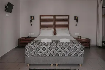 a bedroom with a large bed with two pillows at Tellus City in Chania Town