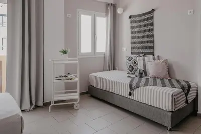 a small bedroom with a bed and a window at Tellus City in Chania Town