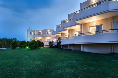 a lawn in front of a building at night at Alonia Hotel Apartments in Kolymvari