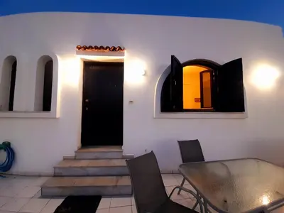 a room with a door and a table and chairs at Brina's House in Kissamos