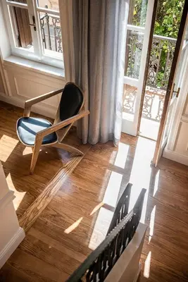 a chair sitting in a room with a window at Alexandra's Lighthouse View in Chania Town
