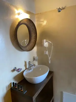 a bathroom with a sink and a mirror on the wall at Captain Vasilis Hotel in Chania Town