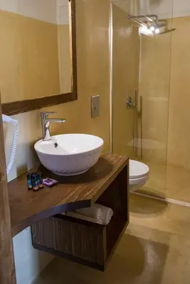 a bathroom with a sink and a toilet and a shower at Captain Vasilis Hotel in Chania Town