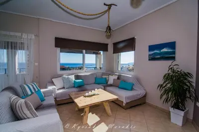 a living room with a couch and a table at La Casa Del Vitsi in Palaiochóra