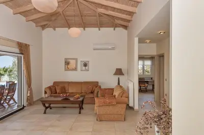 a living room with a couch and a table at Karmilos Hill Villa in Chania Town