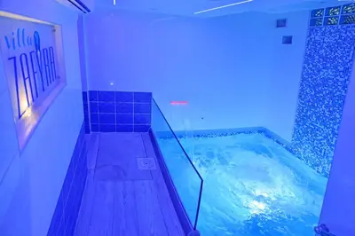 a indoor swimming pool with a jacuzzi in a room at Villa Zafyra in Kissamos