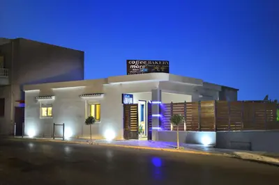 a building with a sign on top of it at night at Villa Zafyra in Kissamos