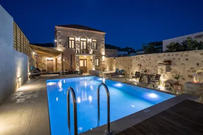 a villa with a swimming pool at night at Villa Theta With Private Pool by Amara Living in Drapaniás