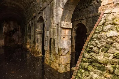 a stone tunnel with two arches on the side at Porto Kalyves Seaside Aparthotel in Kalyves