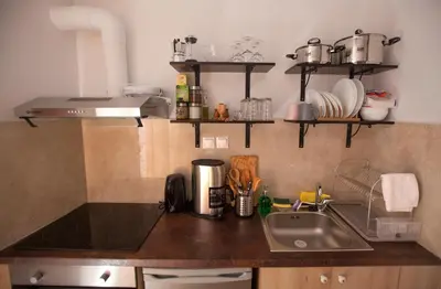 a kitchen with a sink and a counter top at Green Door Apartment in Chania Town