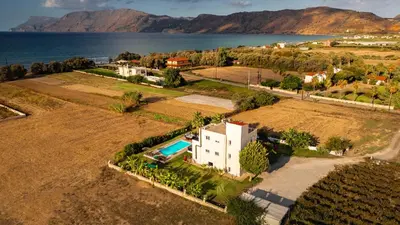 an aerial view of a house next to the water at Martimi Apartments - 200M from Drapanias Beach - Pool - Hot Tub - Sauna - BBQ in Kissamos