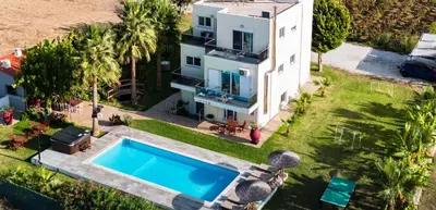 an aerial view of a house with a swimming pool at Martimi Apartments - 200M from Drapanias Beach - Pool - Hot Tub - Sauna - BBQ in Kissamos