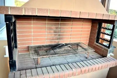 a brick oven with a grill inside of it at Almyrida sea view house in Almirida