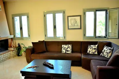 a living room with a couch and a coffee table at Almyrida sea view house in Almirida