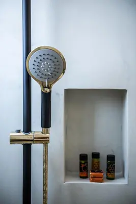 a blow dryer sitting next to a shelf with three candles at Artemide city places- Petite Apartments in Chania Town