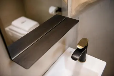 a bathroom sink with a mirror and a knife at Artemide city places- Petite Apartments in Chania Town