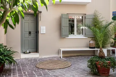 a porch with a bench and a window and a door at Artemide city places- Petite Apartments in Chania Town