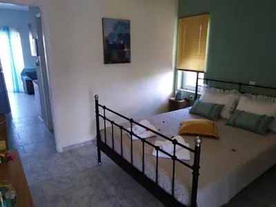a bedroom with a large bed in a room at Marianos Apartments in Kissamos