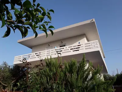 a white building with the words on it at Marianos Apartments in Kissamos