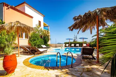 a swimming pool in front of a house at Villa Seli in Gerani Chanion