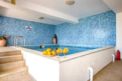 a kitchen with blue tiled walls and a counter with oranges at Villa Seli in Gerani Chanion
