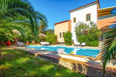 a villa with a swimming pool in front of a house at Villa Seli in Gerani Chanion