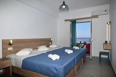 a bedroom with a bed with towels on it at Calypso in Agia Roumeli