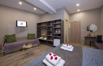 a living room with a bed and a couch at Stoa Suites Chania in Chania Town
