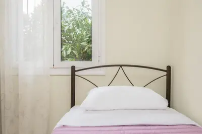 a bed in a room with a window at Nina's House in Kamisianá