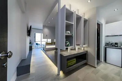 a kitchen with white cabinets and a counter top at Solar Apartments by Amara Living in Agia Marina Nea Kydonias