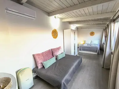 a living room with a couch and a bed at Charming Old Tannery House with Spacious Veranda and Stunning Sea View! in Chania Town