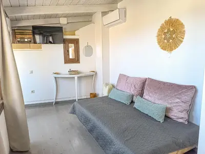 a bedroom with a bed with blue and purple pillows at Charming Old Tannery House with Spacious Veranda and Stunning Sea View! in Chania Town