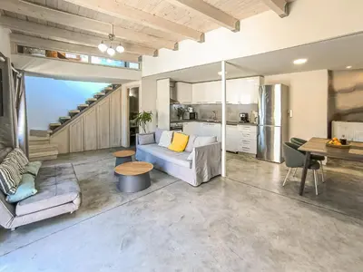 a living room with a couch and a table at Charming Old Tannery House with Spacious Veranda and Stunning Sea View! in Chania Town