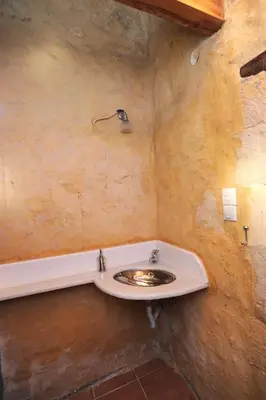 a bathroom with a sink in a stone wall at Villa Alexandrou in Vamos